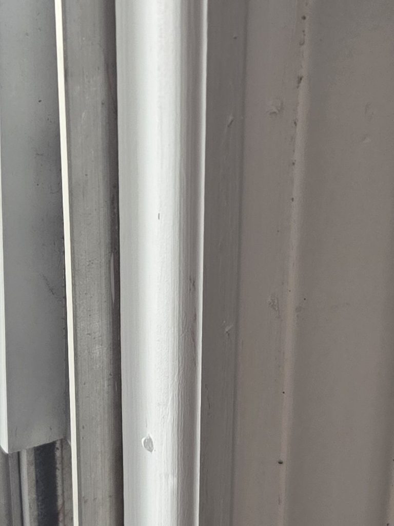 Repaired and restored sliding glass door trim completed by Blue Line Home Services. 